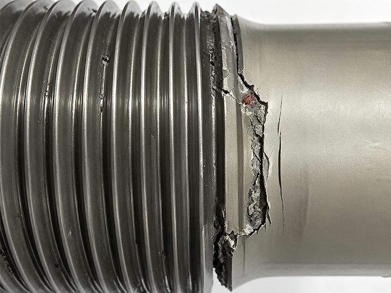 Hydraulic cylinder piston rod thread root crack failure, metal fatigue fracture close-up