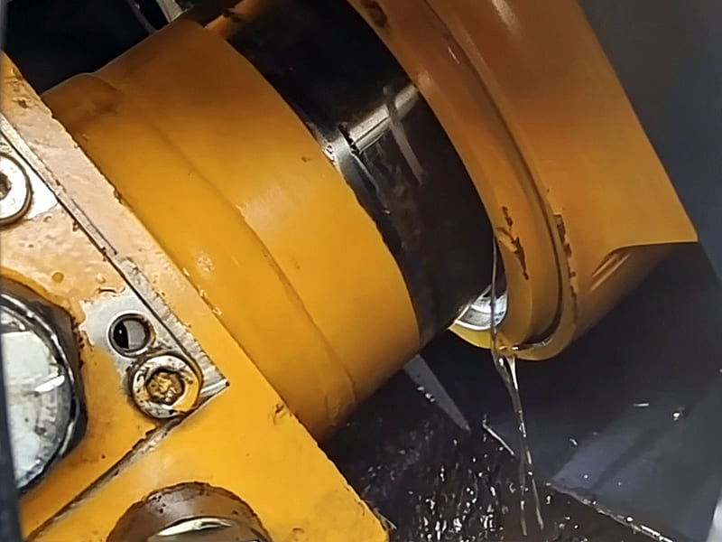 Faulty leaking hydraulic cylinder, oil leakage from piston rod seal