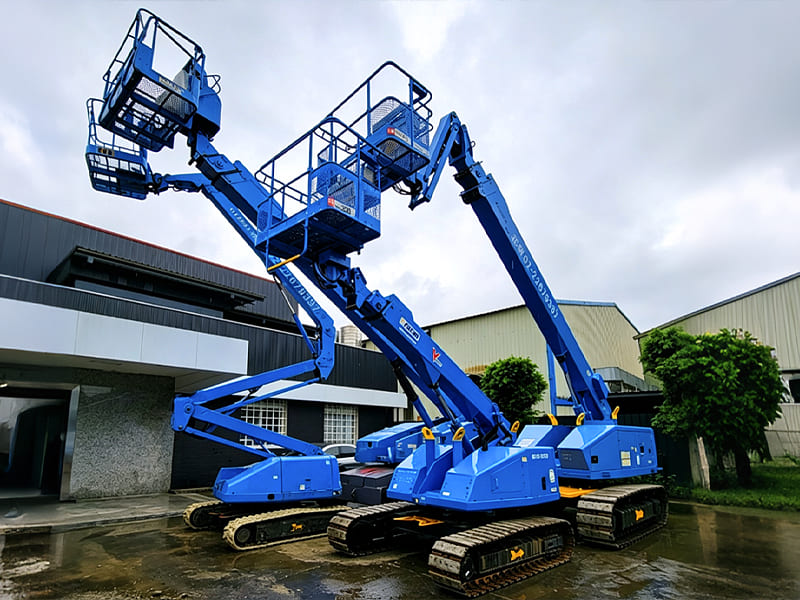 Blue crawler articulated boom lift, rough‑terrain aerial work platform for construction