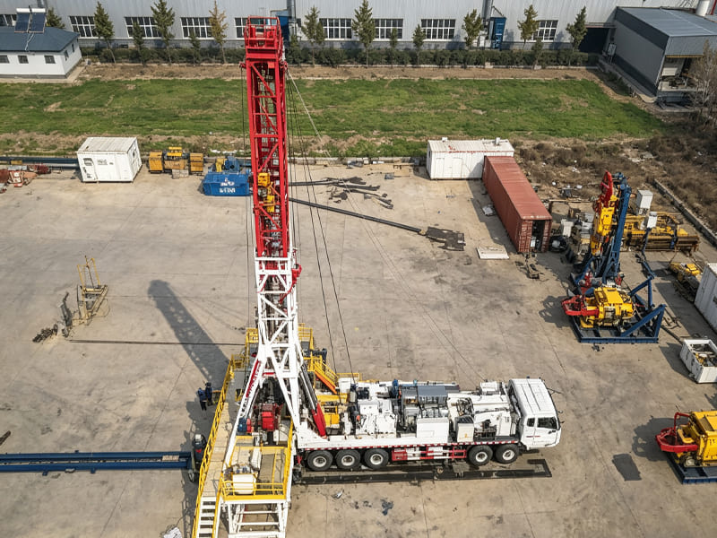 Aerial view of truck‑mounted mobile oil drilling rig in factory yard