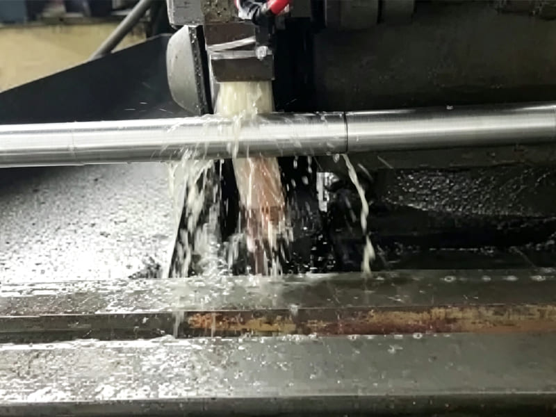 CNC lathe processing polished hydraulic cylinder piston rod with cooling liquid