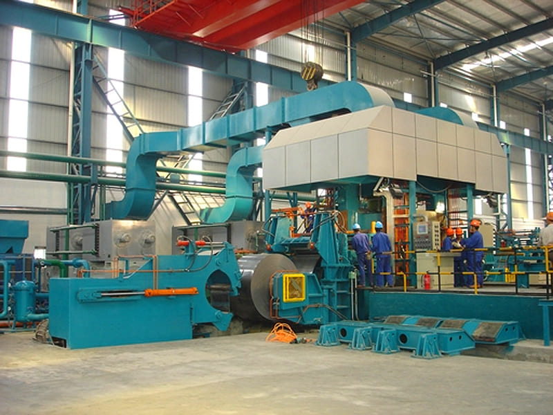 Large industrial aluminum coil rolling mill equipment inside metallurgical plant workshop