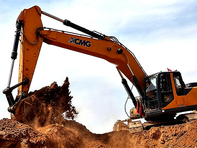Orange XCMG excavator digging soil with hydraulic boom cylinders in operation