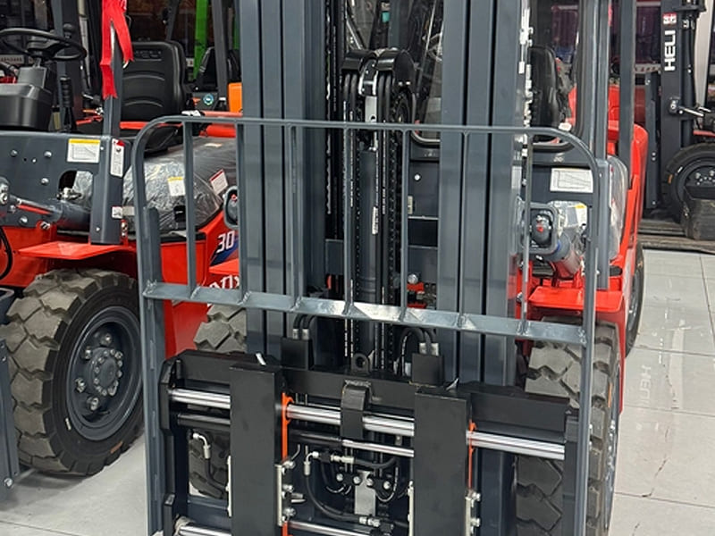 View of forklift carriage with hydraulic side shift attachment inside showroom