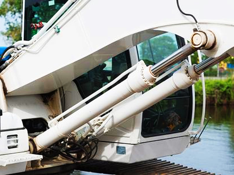Close‑up of hydraulic cylinders installed on excavator boom