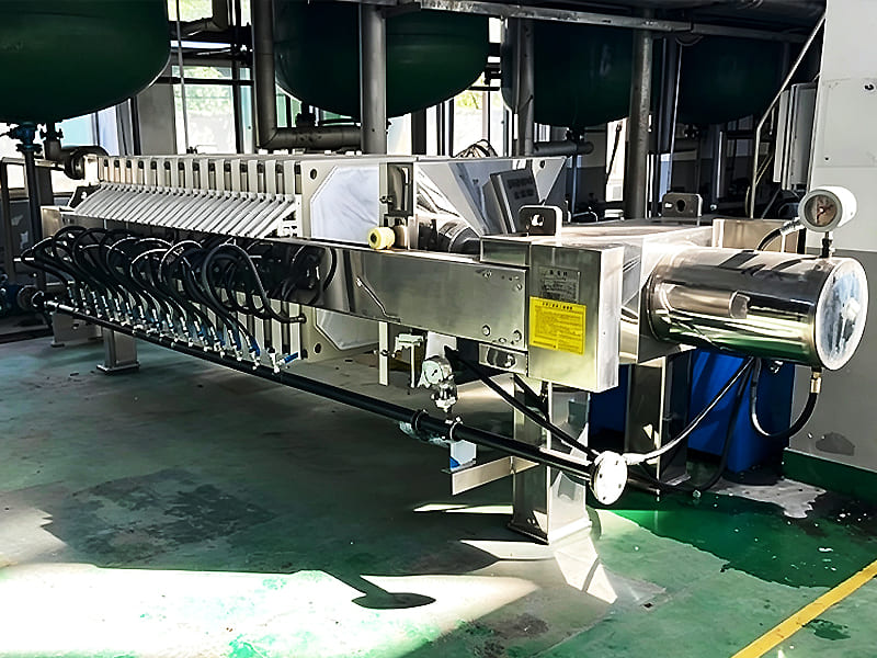 Full view of sanitary stainless steel plate‑and‑frame filter press equipment in plant