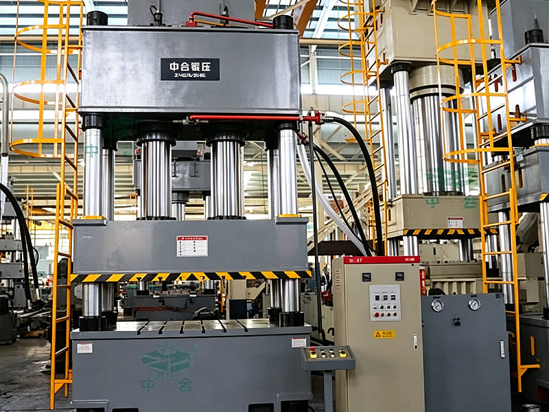 Large four‑column hydraulic press machine in workshop