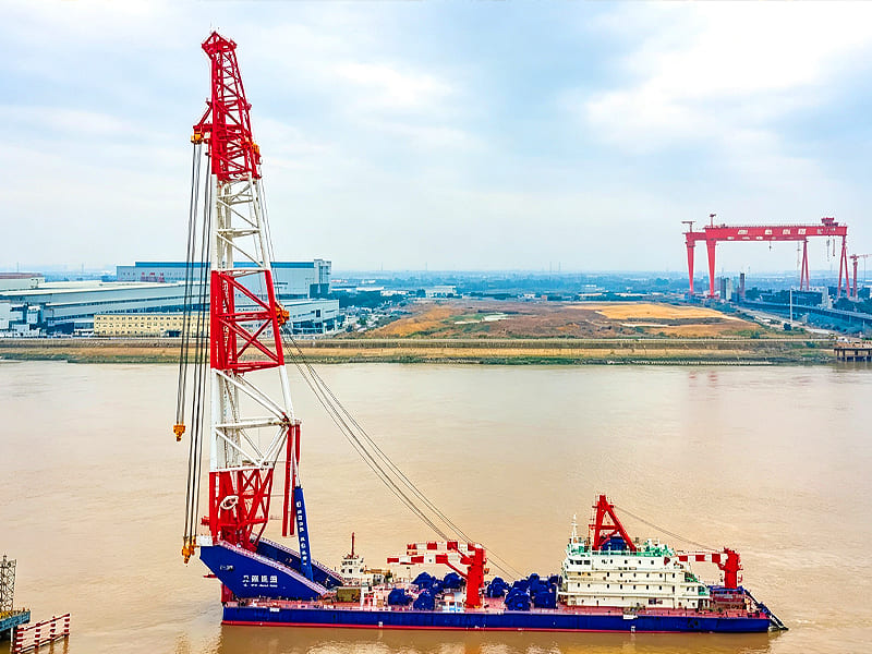 Large offshore floating crane ship moored on river water
