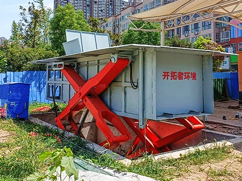 Hydraulically driven scissor lift underground waste compression equipment on site