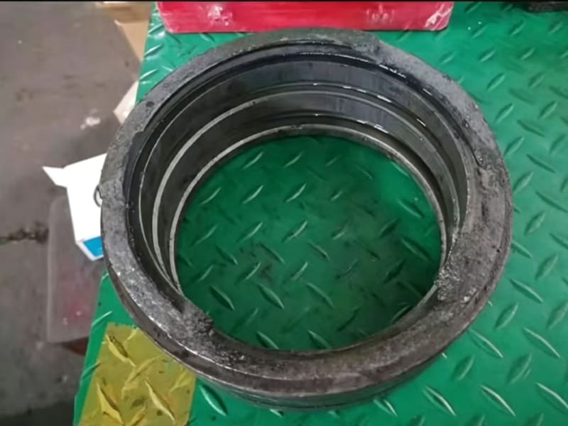 Used cylinder head gland with failed oil seal and dirt contamination