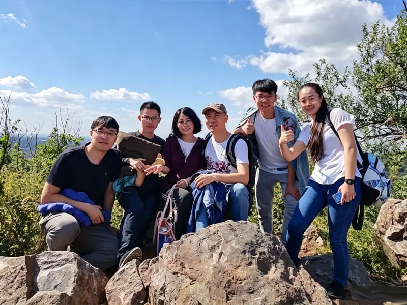 Enterprise team group photo taken during mountain hiking activity