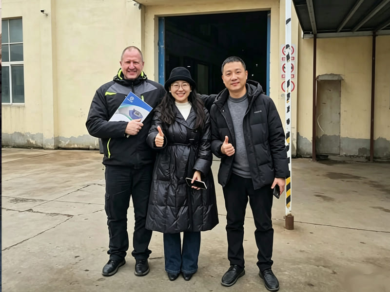 Business team photo with foreign customers after factory audit