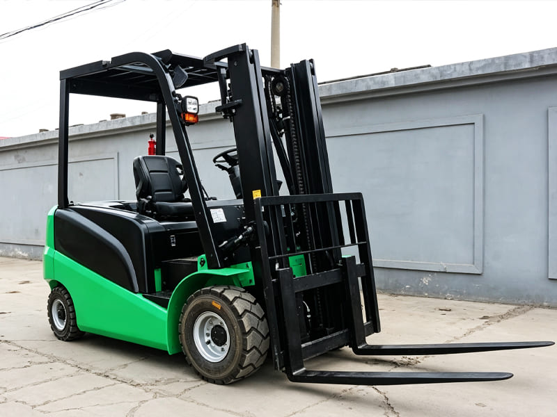 Green and black electric counterbalance forklift outdoors against grey wall