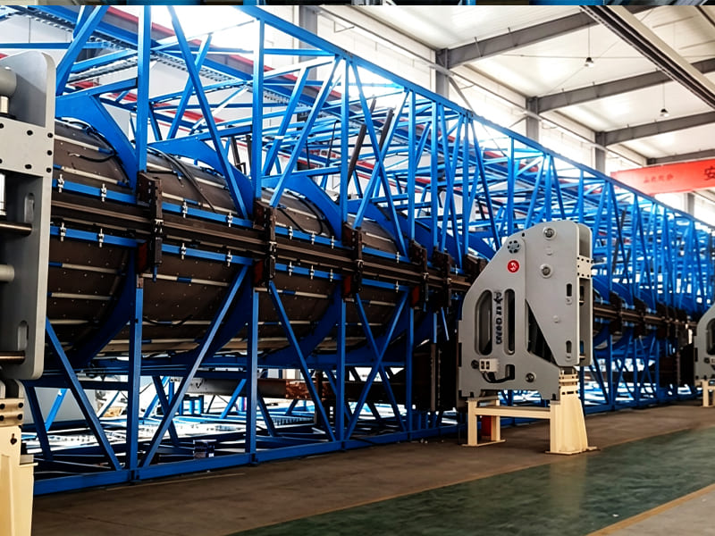 Huge blue truss‑structured industrial production line equipment inside modern manufacturing workshop