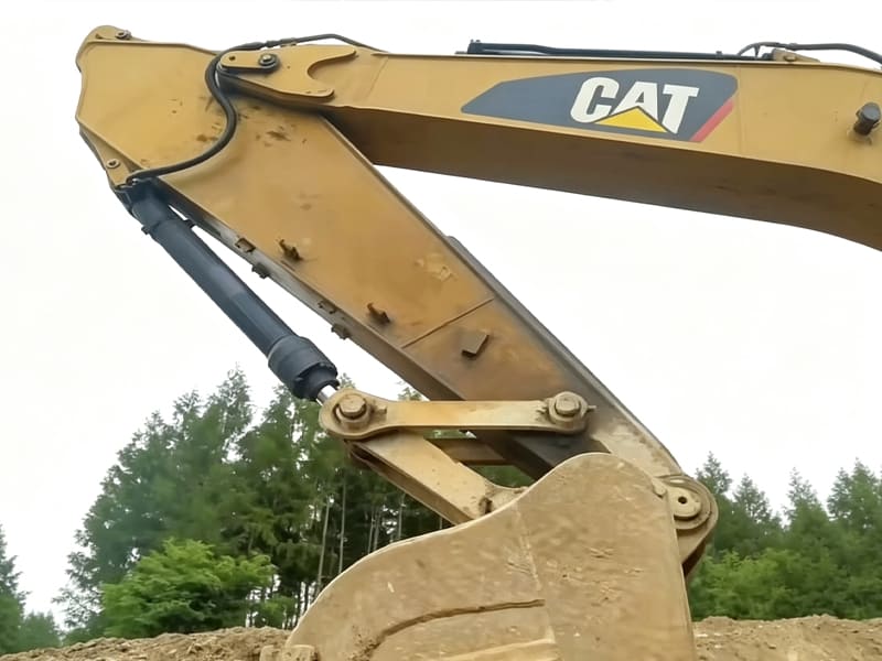 Side shot of CAT excavator boom arm, stick and bucket linkage cylinder