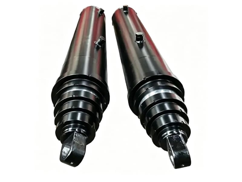 Two black heavy‑duty telescopic hydraulic cylinders for dump truck, white background