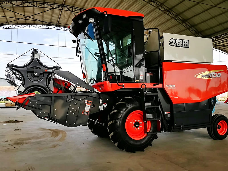 Red Kubota PRO1108 grain combine harvester parked inside warehouse