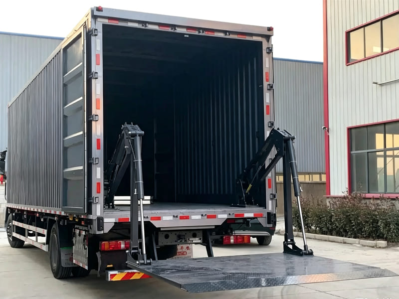 New box truck fitted with dual hydraulic cylinder tail lift, platform unfolded