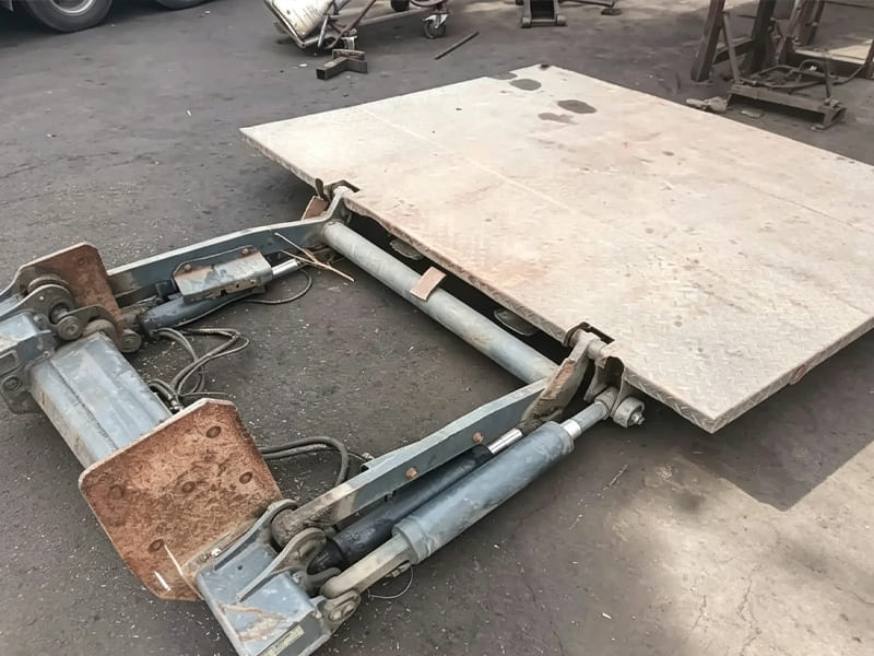 Disassembled second-hand hydraulic tailgate with cylinders and hinged platform
