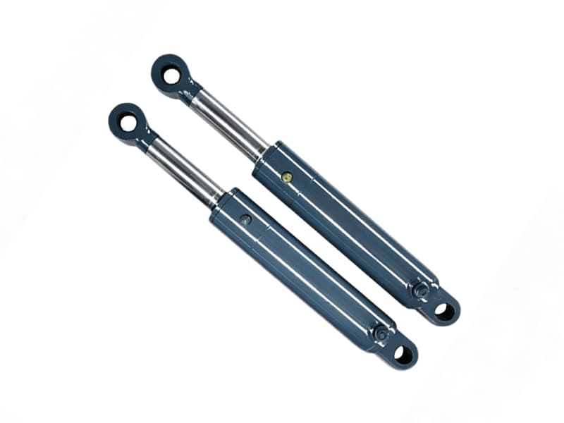 Two grey-blue welded hydraulic cylinders with polished piston rods