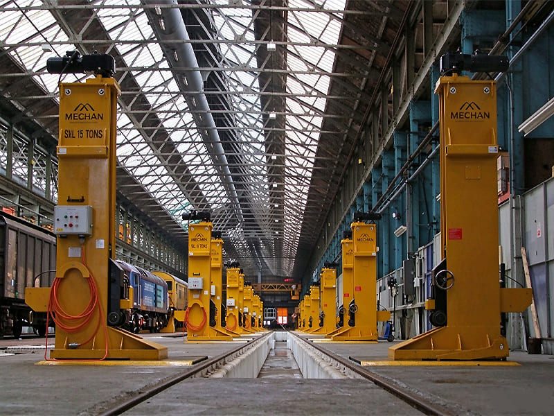 1. Row of heavy hydraulic lifting jacks used for train wagon maintenance inside rail workshop