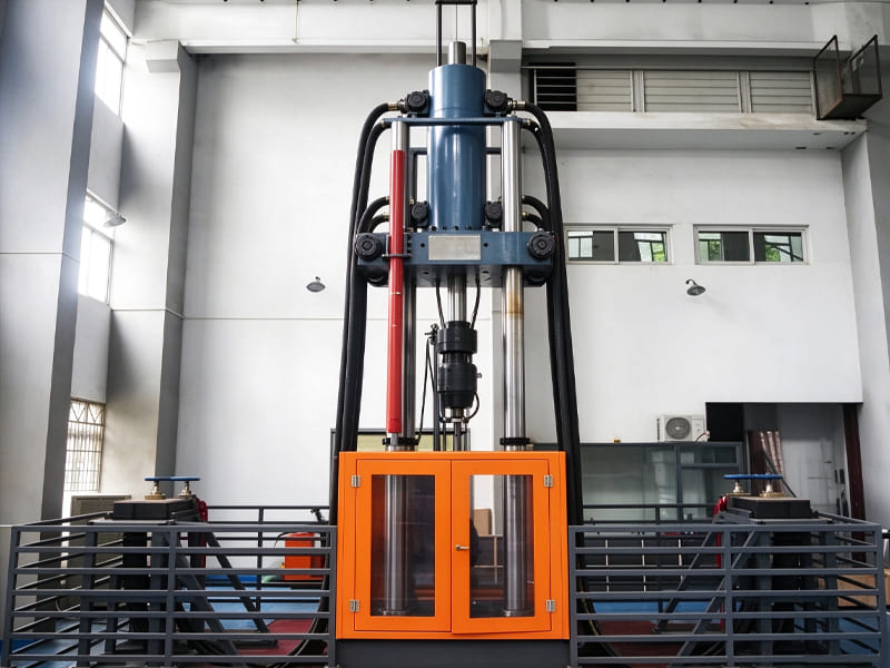 Vertical hydraulic material testing machine with large bore hydraulic cylinder