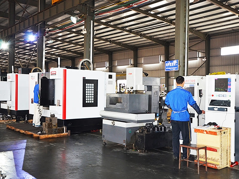 Factory workshop scene, workers operate CNC machine tools for hydraulic cylinder parts processing
