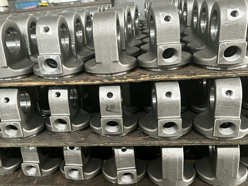 1. Machined cast hydraulic cylinder hinge ear end caps stacked on pallet
